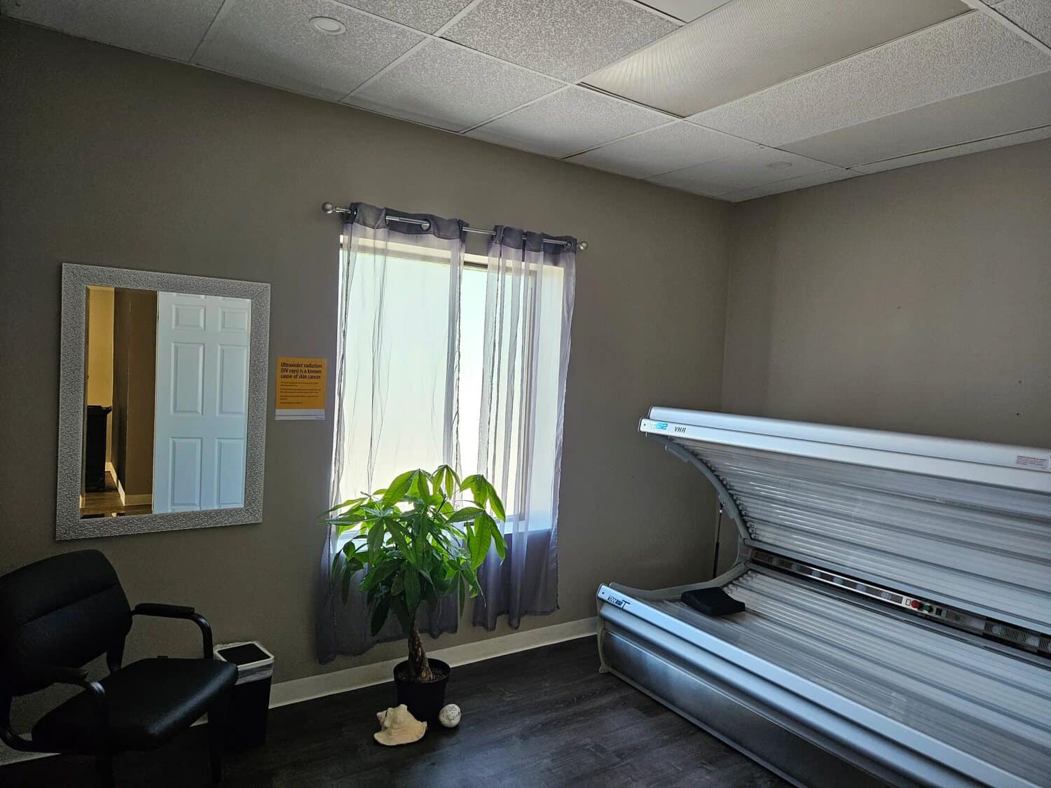 Lay-down tanning bed in a private room at Sugar Palm Spa