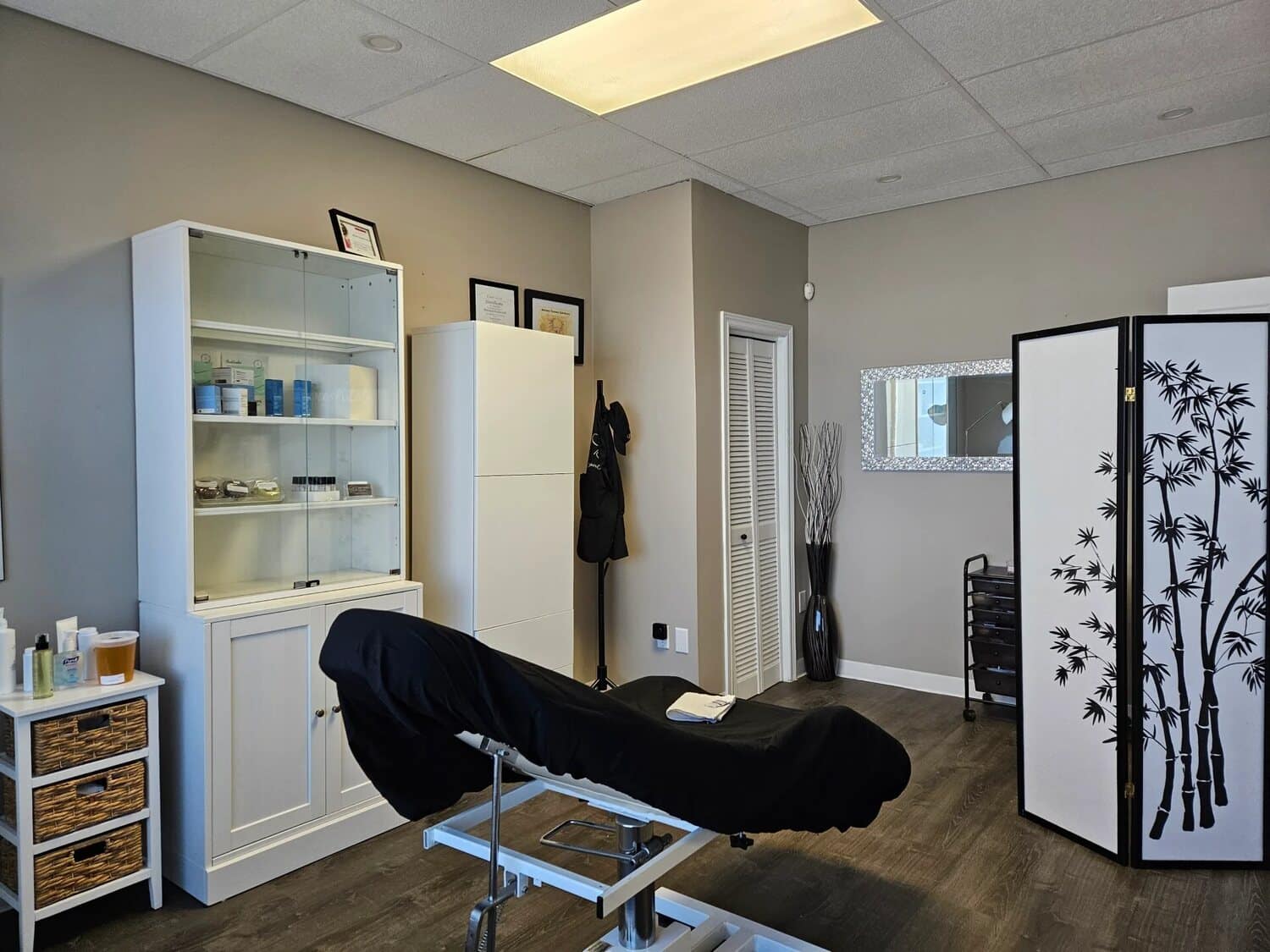 Treatment room at Sugar Palm Spa with a covered table and a bamboo privacy screen